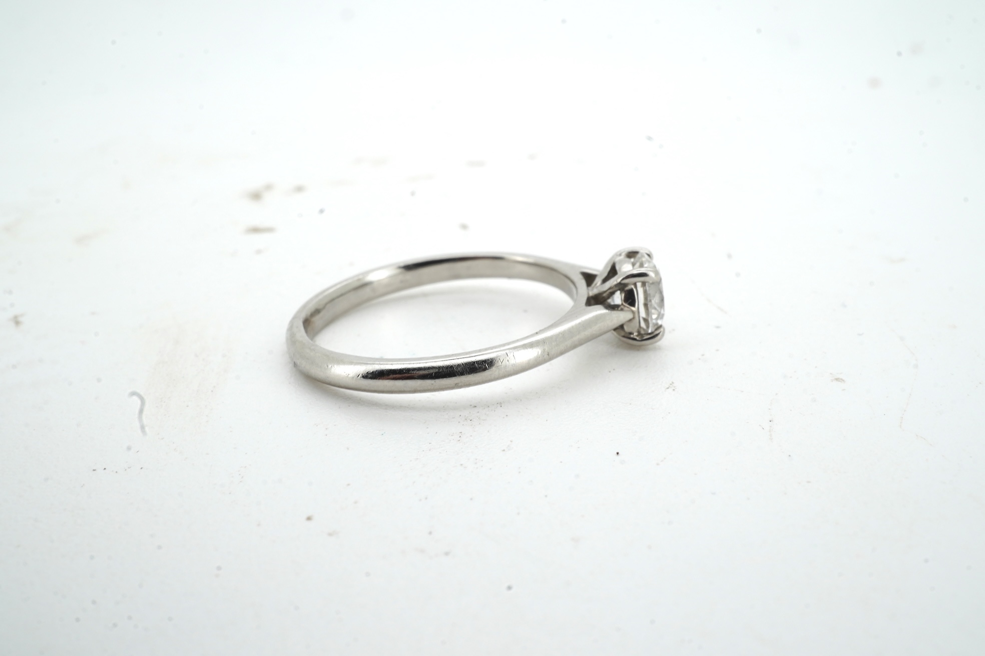 A diamond ring, claw-set with a brilliant-cut diamond weighing approximately 0.61 carats, mounted in platinum, size L, British hallmarks, gross weight approximately 3 grams